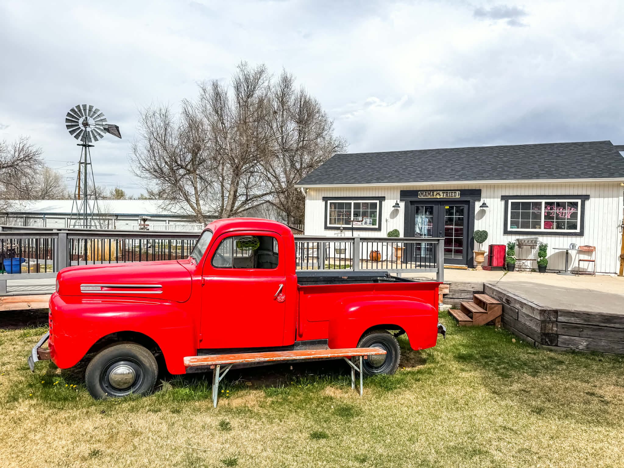 Mama Tried Boutique storefront with vintage red truck and windmill in Elizabeth, Colorado